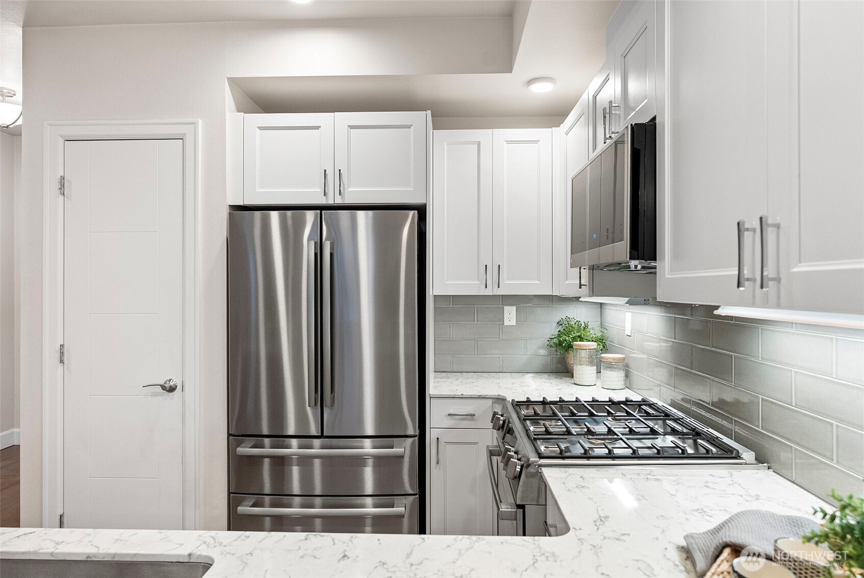 4961 Main Street, Unit 814 Tacoma, WA 98407 - Photo 4 of 37 a kitchen with stainless steel appliances granite countertop a refrigerator and a stove top oven