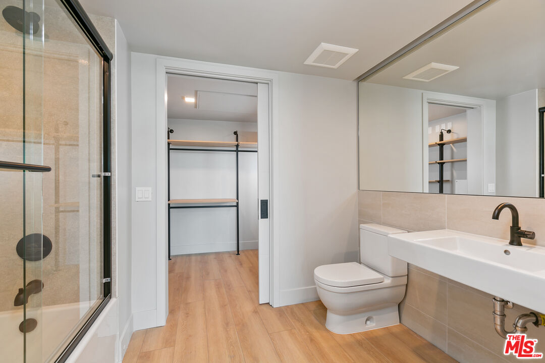 12431 Rochester Avenue, Unit 208 Los Angeles, CA 90025 - Photo 13 of 24 a bathroom with a sink toilet a shower and a mirror