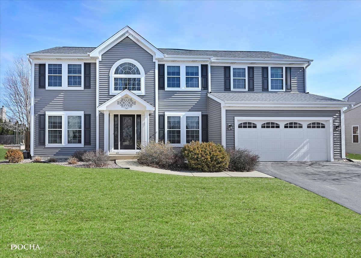 420 Raintree Drive Oswego, IL 60543 - Photo 1 of 51 a front view of a house with a garden