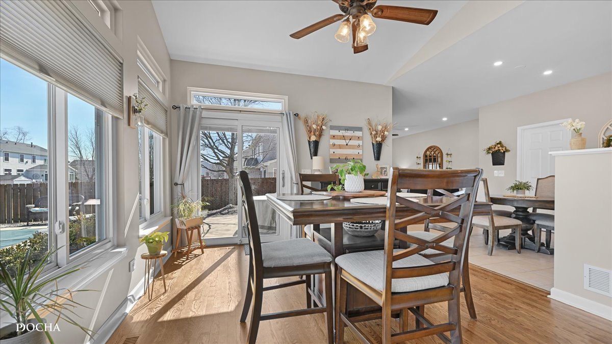 420 Raintree Drive Oswego, IL 60543 - Photo 14 of 51 a view of a dining room with furniture window and wooden floor