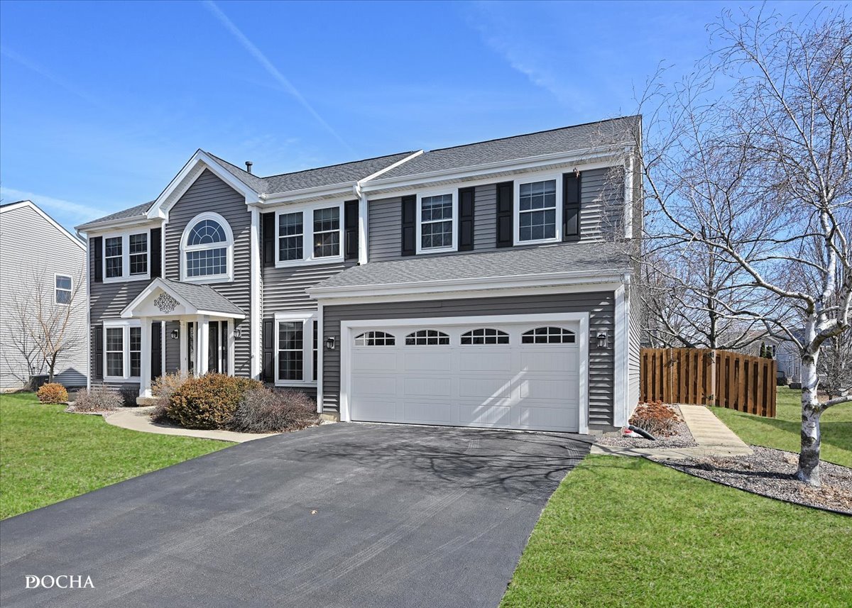 420 Raintree Drive Oswego, IL 60543 - Photo 2 of 51 a front view of a house with garden and garage
