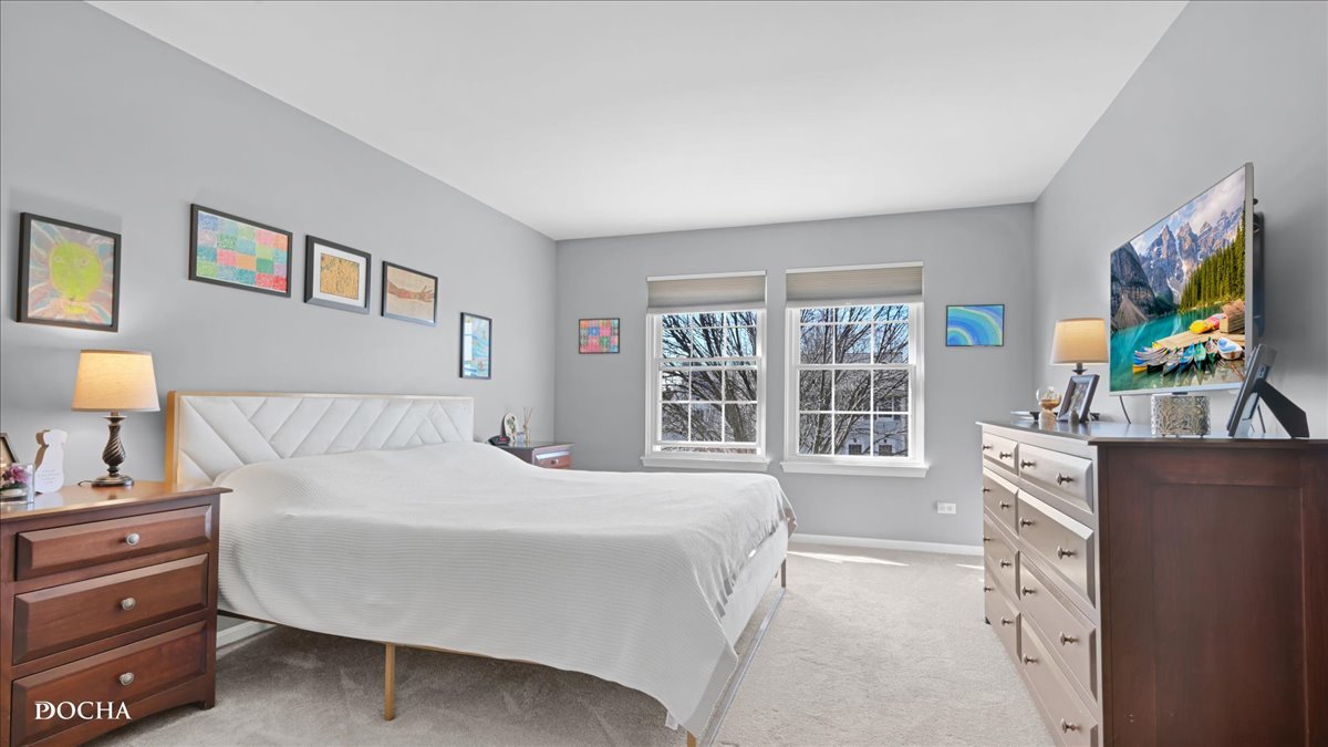 420 Raintree Drive Oswego, IL 60543 - Photo 24 of 51 a bedroom with a bed and a flat screen tv