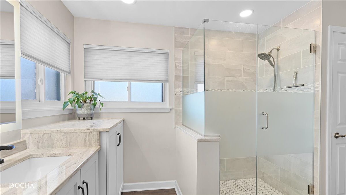 420 Raintree Drive Oswego, IL 60543 - Photo 27 of 51 a bathroom with a granite countertop shower a sink and a mirror