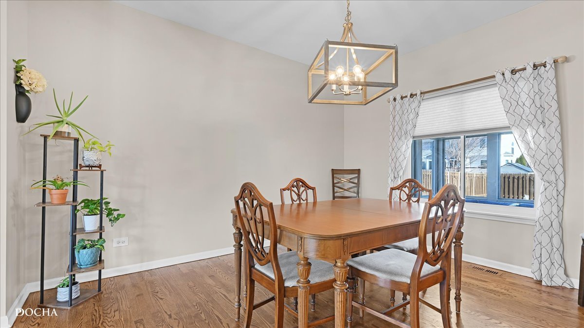420 Raintree Drive Oswego, IL 60543 - Photo 7 of 51 a view of a dining room with furniture wooden floor and a chandelier