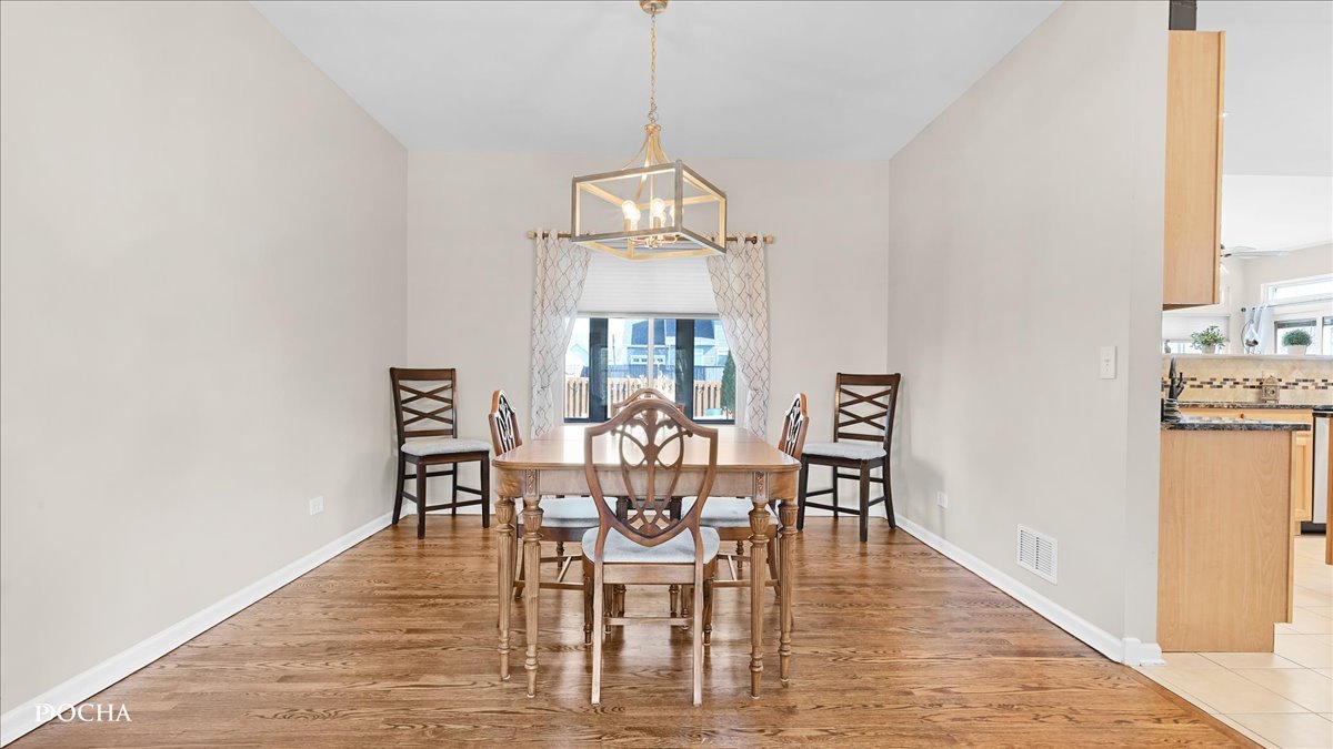 420 Raintree Drive Oswego, IL 60543 - Photo 8 of 51 a view of a dining room with furniture window and wooden floor