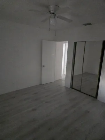 an empty room with windows and fireplace