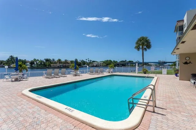 a view of a swimming pool and lounge chairs