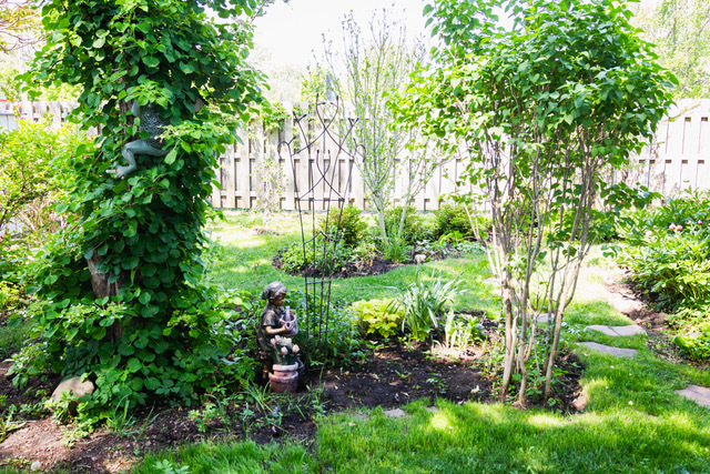 38569 North Sheridan Road, Unit 390 Beach Park, IL 60099 - Photo 24 of 28 a backyard of a house with lots of green space and garden