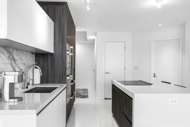a kitchen with a sink and a refrigerator