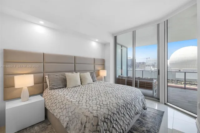 a bedroom with a large bed and a view of bedroom