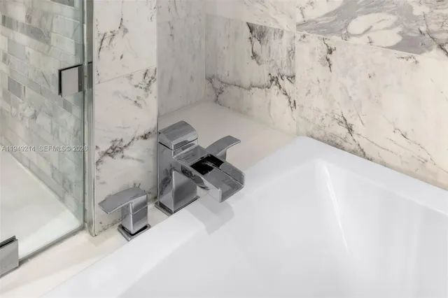 a bath tub sitting next to a white wall