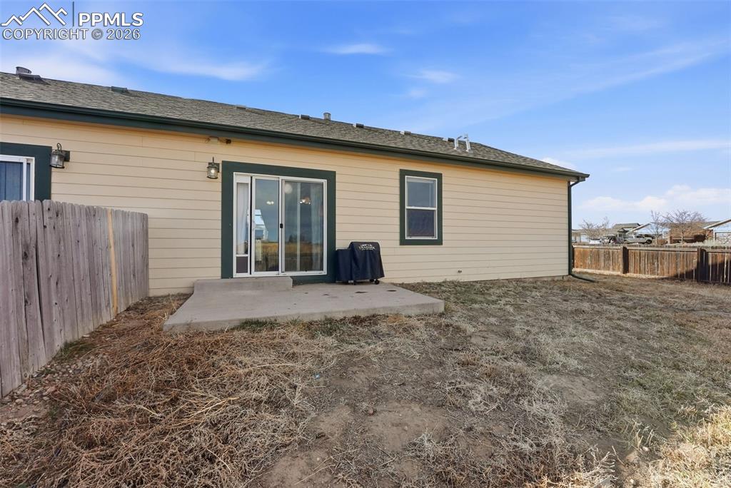 6535 Gelbvieh Road Peyton, CO 80831 - Photo 27 of 41 Rear view of property featuring a patio area and a fenced backyard