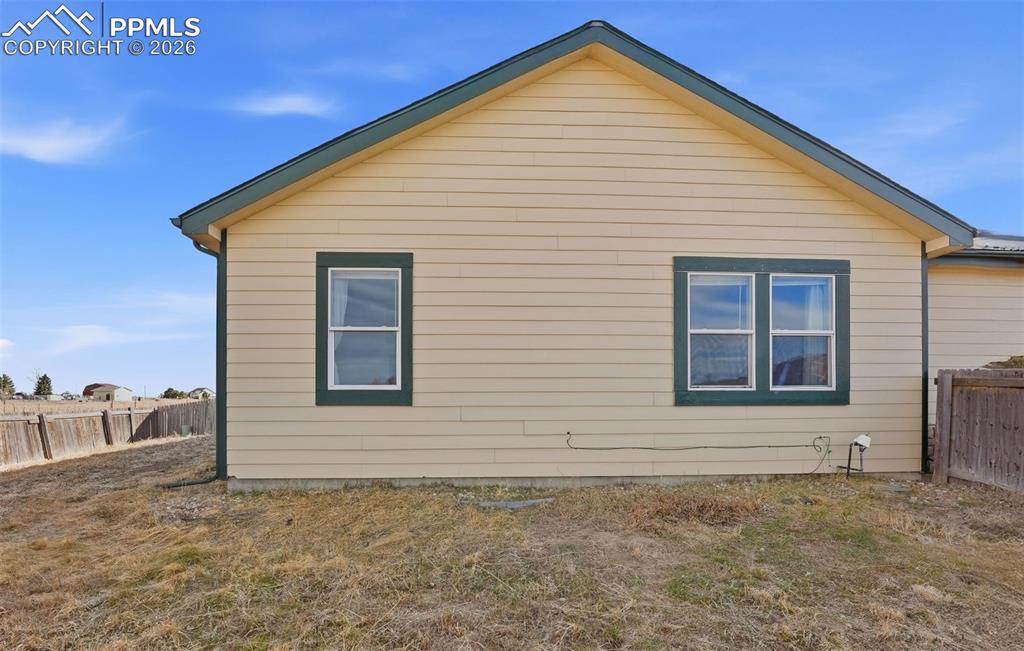 6535 Gelbvieh Road Peyton, CO 80831 - Photo 30 of 41 View of home's exterior with a fenced backyard