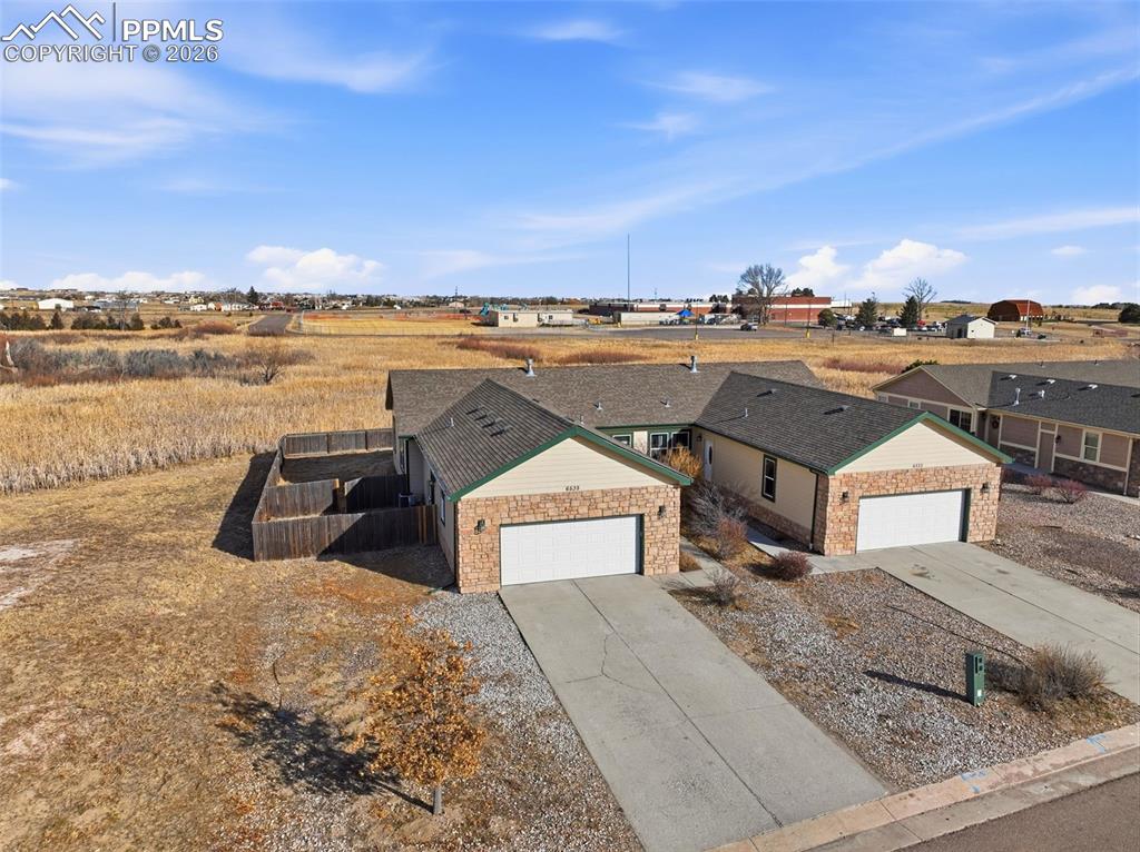 6535 Gelbvieh Road Peyton, CO 80831 - Photo 36 of 41 View of front of house featuring driveway and an attached garage