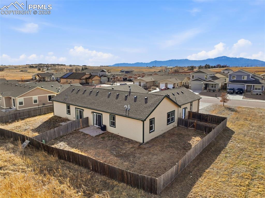 6535 Gelbvieh Road Peyton, CO 80831 - Photo 37 of 41 Aerial perspective of suburban area featuring a mountainous background