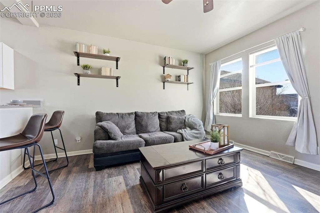6535 Gelbvieh Road Peyton, CO 80831 - Photo 7 of 41 Living area featuring ceiling fan and dark wood-style floors