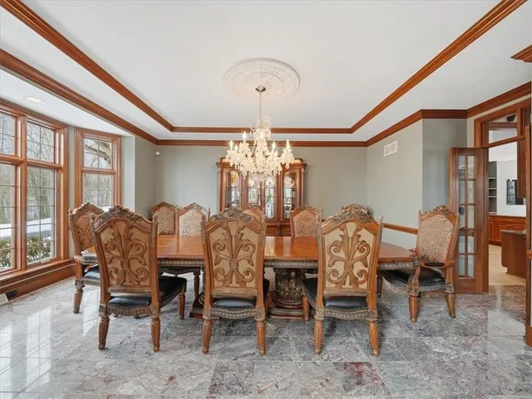 a dining room with furniture a chandelier and a rug