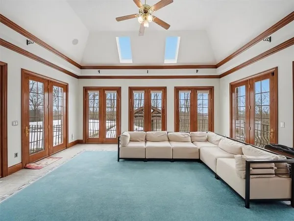 a living room with furniture and large windows