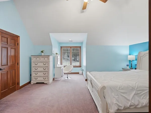 a room with a bed and dresser