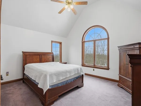 a bed sitting in a bedroom next to a window