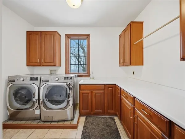 a utility room with sink dryer and washer
