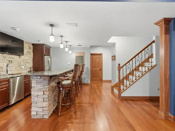 a view of a kitchen with furniture and wooden floor