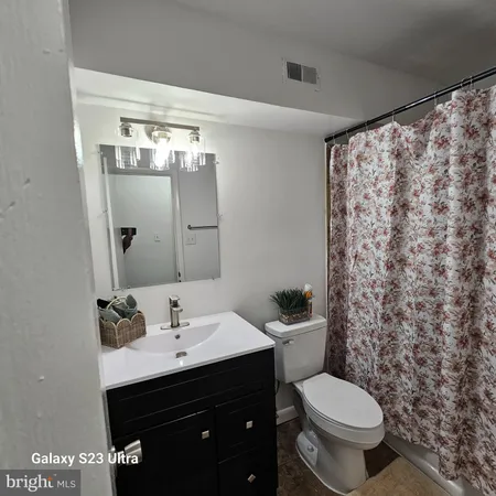 a bathroom with a sink toilet and mirror