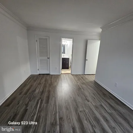 a view of a room with wooden floor