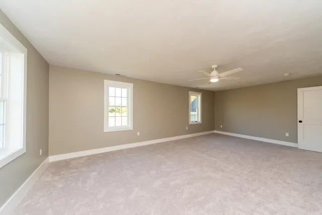 a spacious bathroom with a double vanity sink a mirror and a bathtub