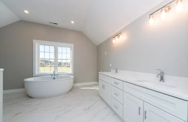 a bathroom with a tub sink and shower