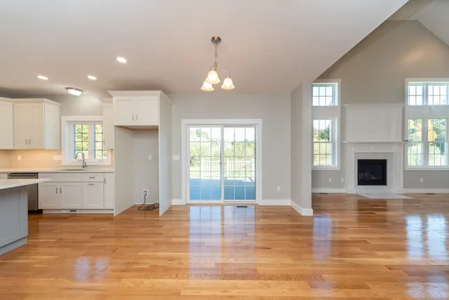a view of empty room with wooden floor and fireplace
