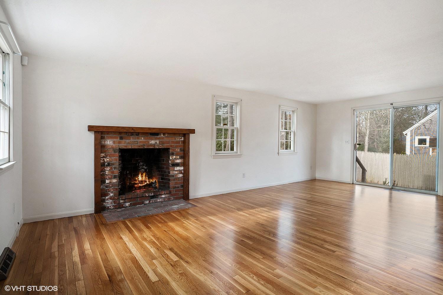 40 Nathan Road Centerville, MA 02632 - Photo 3 of 12 a view of empty room with wooden floor and fireplace
