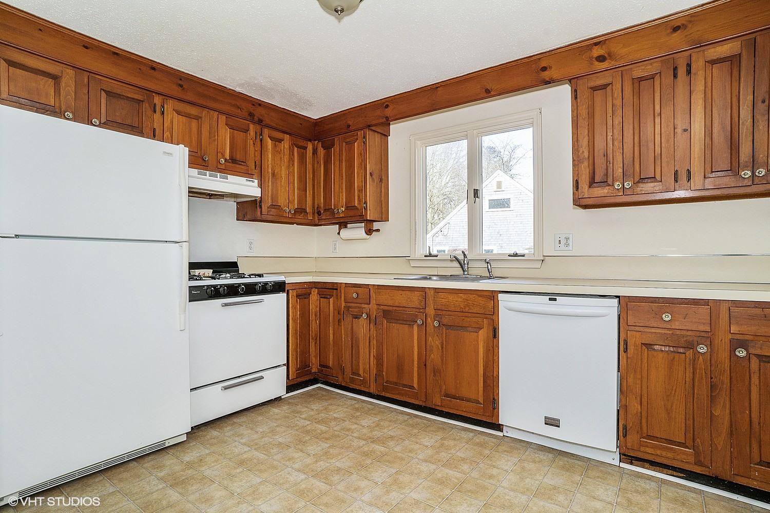 40 Nathan Road Centerville, MA 02632 - Photo 4 of 12 a kitchen with granite countertop a refrigerator sink stove and cabinets