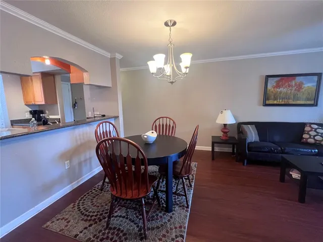 a view of a dining room with furniture and chandelier