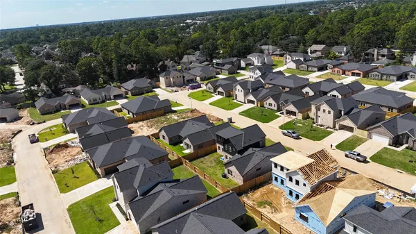 an aerial view of a swimming pool and lounge chairs