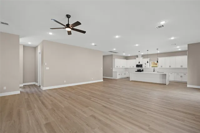 a view of a kitchen with a dishwasher wooden floor and a refrigerator