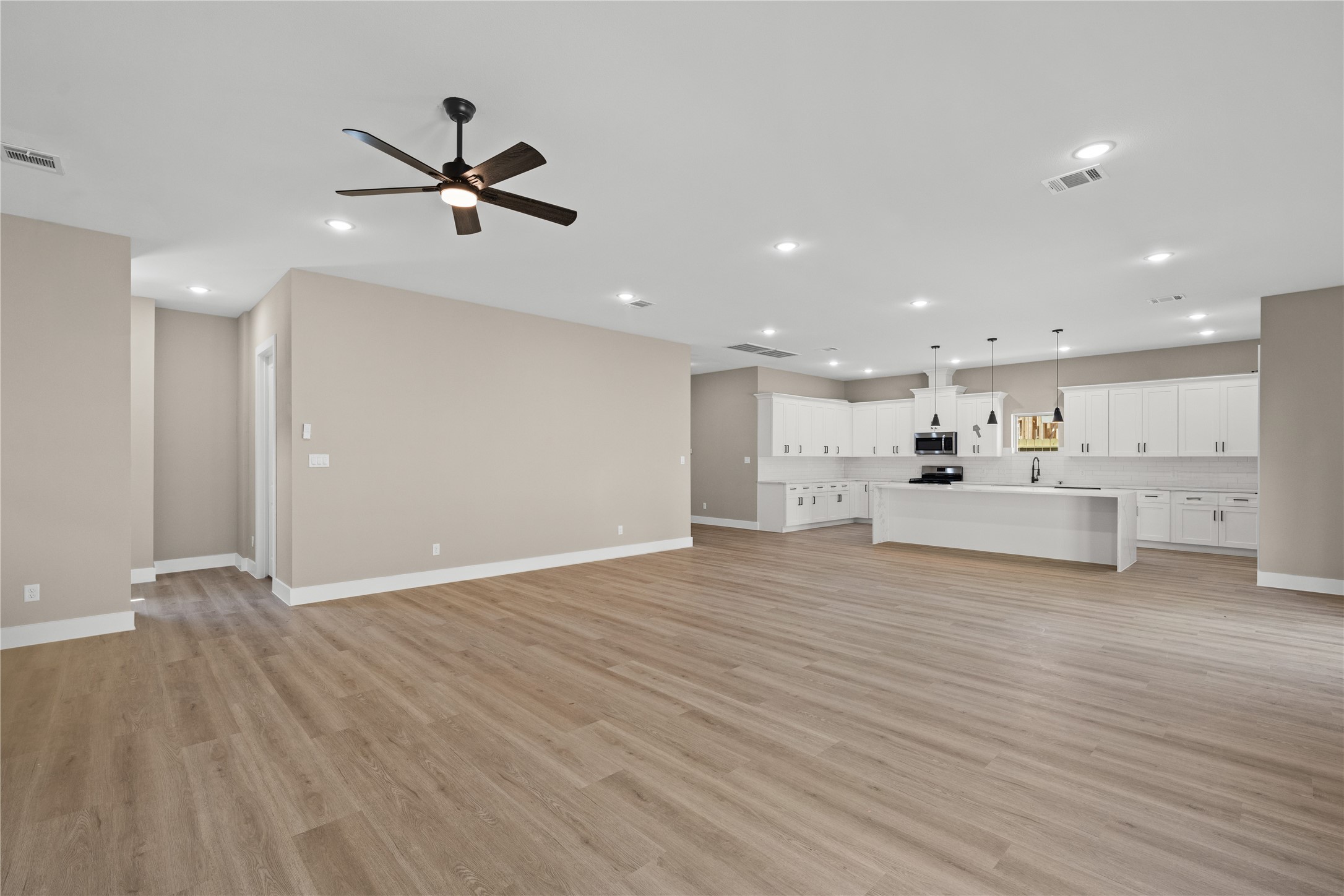 2610 Piemonte Ave Spring Spring, TX 77388 - Photo 6 of 23 a view of a kitchen with a dishwasher wooden floor and a refrigerator