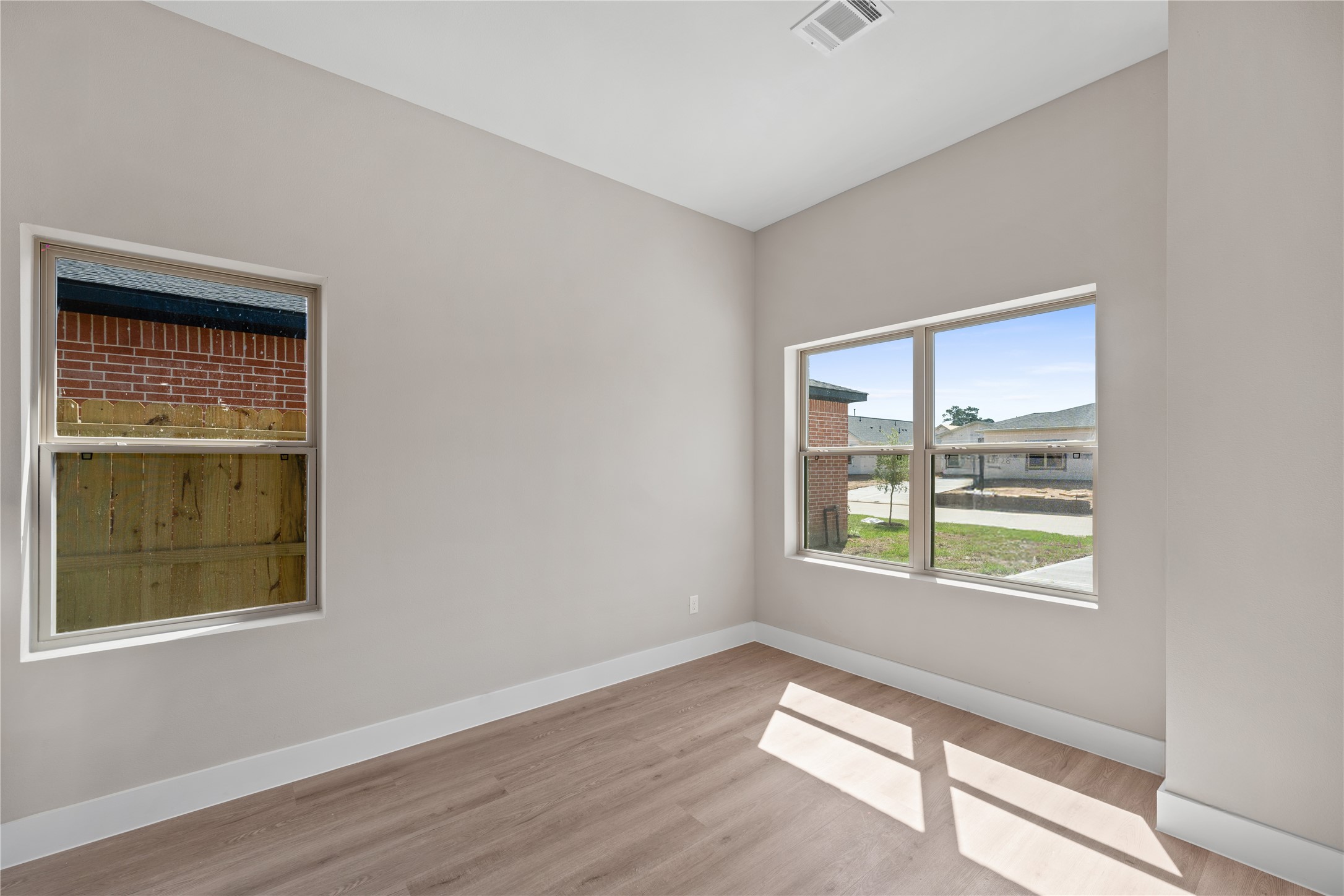 2610 Piemonte Ave Spring Spring, TX 77388 - Photo 10 of 23 a view of an empty room with wooden floor and a window