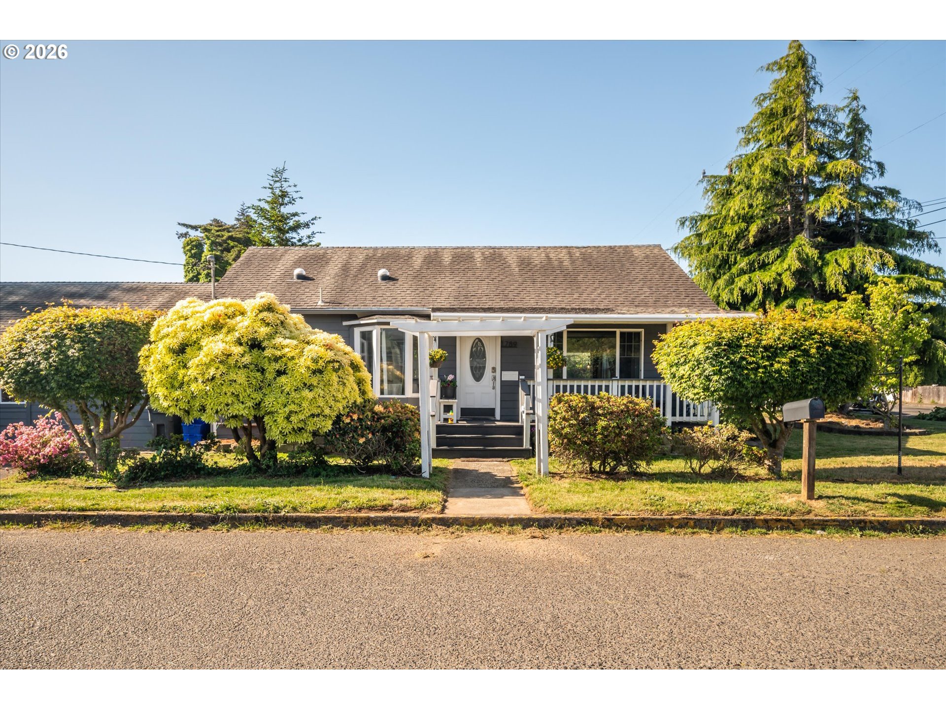 1789 14th Street North Bend, OR 97459 - Photo 1 of 43 a front view of a house with garden