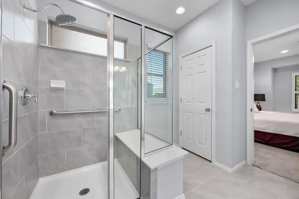 a bathroom with a shower and a sink