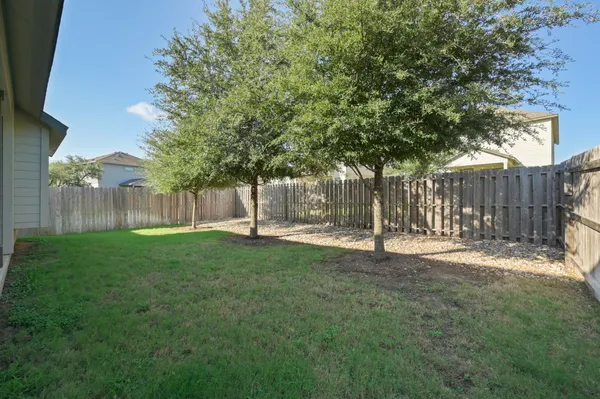 a backyard of a house with table and chairs