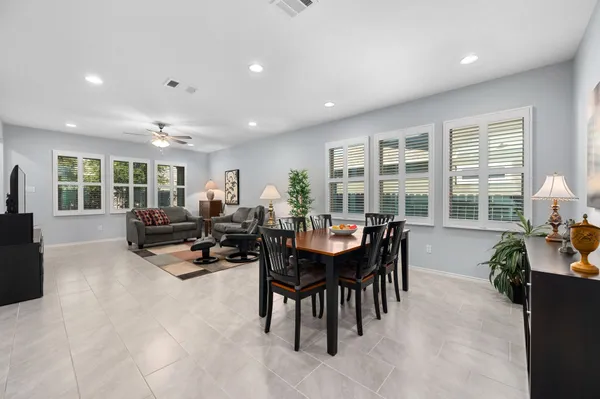 a living room with furniture and large windows