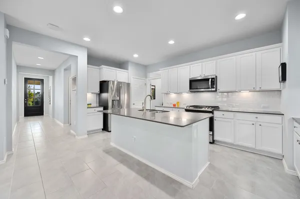 a kitchen with granite countertop a sink and stainless steel appliances