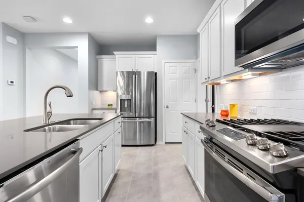 a kitchen with a sink stove and refrigerator