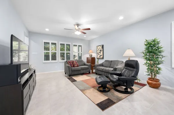 a living room with furniture and a potted plant