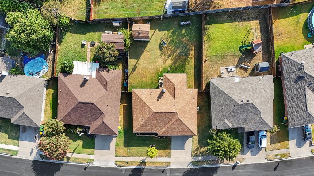 7624 Maple Hill Road Watauga, TX 76148 - Photo 2 of 20 Residential property with a gabled roof, paved driveway, and fenced backyard