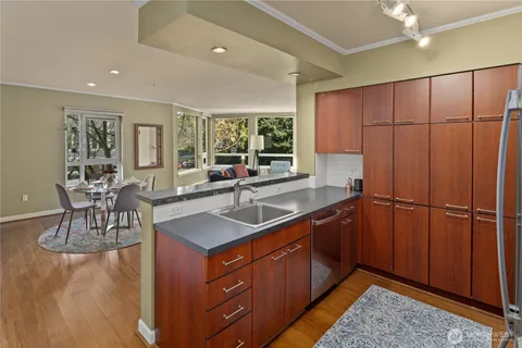 a kitchen with stainless steel appliances granite countertop sink cabinets and window
