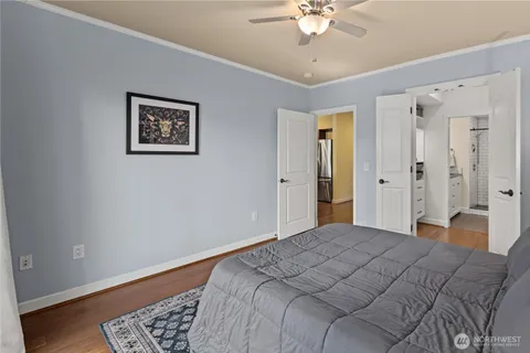 a bedroom with a large bed and a chandelier
