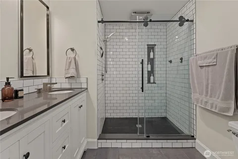a bathroom with a granite countertop sink a shower and a mirror