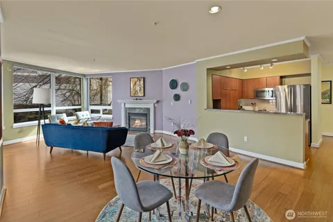 a living room with fireplace furniture and a dining table